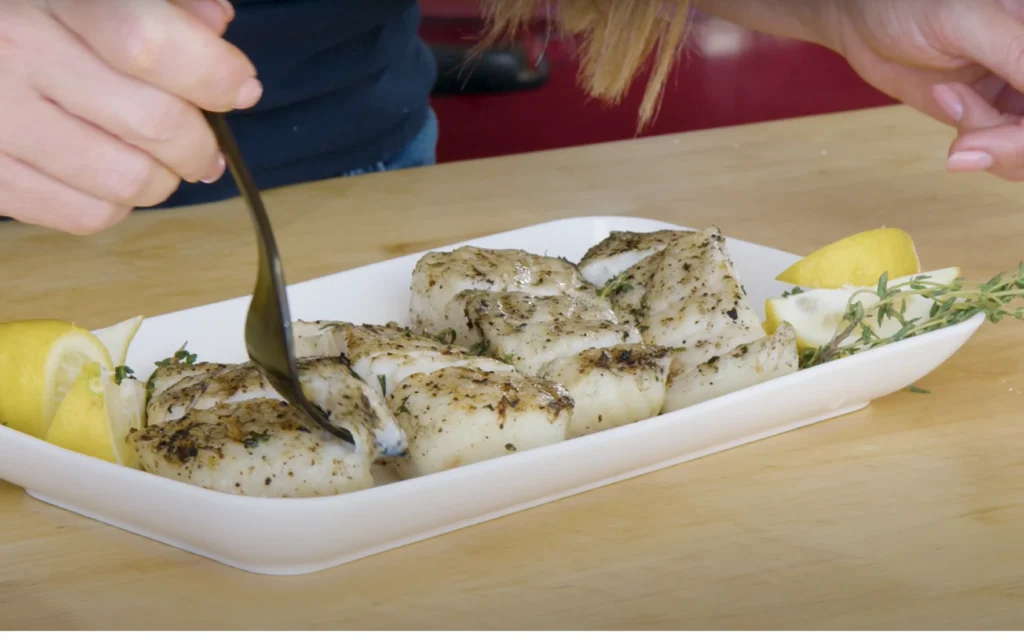A platter of grilled halibut filets, seasoned with a savory blend of paprika, cumin, garlic, and fresh herbs. The fish sizzles under the warm glow of a backyard grill, its crisp, caramelized exterior contrasting with the tender, flaky interior. Lemon wedges and a sprinkle of coarse sea salt add a bright, zesty accent. In the background, a verdant garden provides a lush, natural setting, hinting at the summer's bounty. Soft, diffused lighting casts a golden hue, creating an inviting, mouthwatering atmosphere. The composition emphasizes the succulent halibut as the star of the dish, presented in a way that celebrates its simple, yet delicious preparation. A platter of grilled halibut filets, seasoned with a savory blend of paprika, cumin, garlic, and fresh herbs. The fish sizzles under the warm glow of a backyard grill, its crisp, caramelized exterior contrasting with the tender, flaky interior. Lemon wedges and a sprinkle of coarse sea salt add a bright, zesty accent. In the background, a verdant garden provides a lush, natural setting, hinting at the summer's bounty. Soft, diffused lighting casts a golden hue, creating an inviting, mouthwatering atmosphere. The composition emphasizes the succulent halibut as the star of the dish, presented in a way that celebrates its simple, yet delicious preparation.
