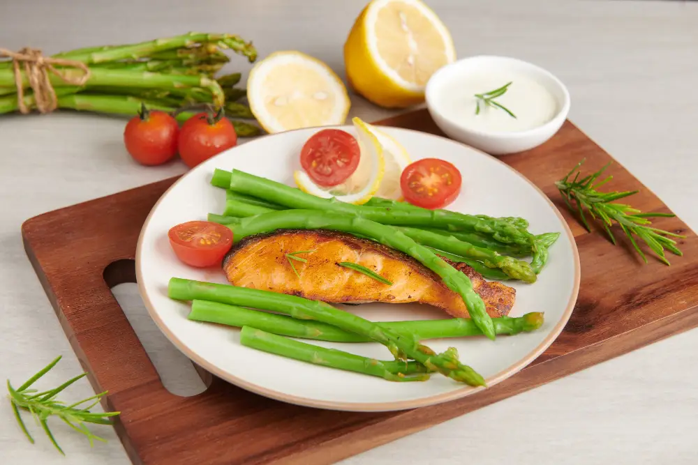 A beautifully styled plate showcasing a selection of freshly roasted asparagus spears, their vibrant green hues glistening under soft, natural lighting. The asparagus is arranged in a visually appealing manner, with some spears standing upright, others artfully scattered across the plate. The image captures the aroma and texture of the roasted asparagus, inviting the viewer to imagine the savory, caramelized notes of this simple yet delectable dish. In the background, a neutral-toned surface, such as a rustic wooden table or a minimalist ceramic plate, provides a clean, uncluttered backdrop to highlight the star ingredient. This image perfectly illustrates the "Flavor Variations and Seasoning Ideas" section, inspiring the reader to experiment with different seasonings and cooking techniques to elevate their roasted asparagus. A beautifully styled plate showcasing a selection of freshly roasted asparagus spears,