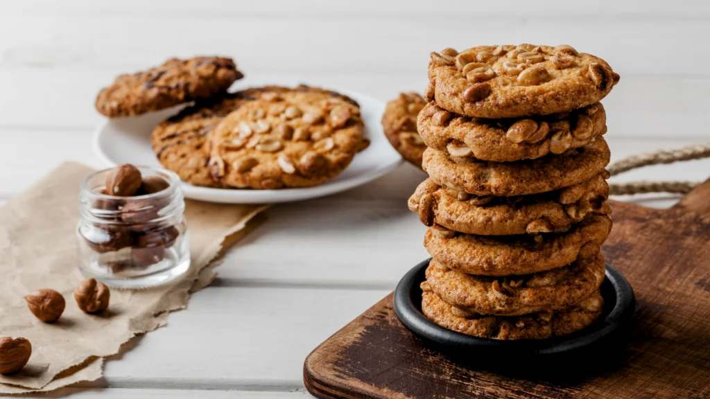 Image of a peanut butter cookie with a bite taken out, showcasing the inside texture. milk free desserts